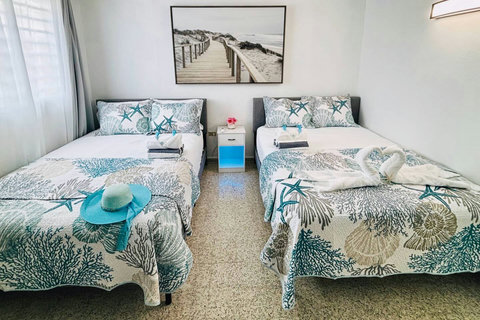 4th Bedroom: Bright and beachy retreat with two queen beds and ocean-inspired decor!