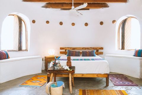 Cool, Comfortable and Safe. Theres a special feeling when you step inside our earth dome. The round thick walls made from rammed earth. The curves and egg shape makes it strong.  
I slept here during a storm, 2 trees fell on it, zero damage.