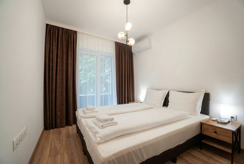 Bright modern twin bedroom with blackout curtains and AC