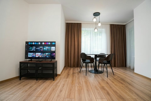 Bright modern lounge with smart TV and cozy dining nook