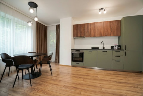 Bright modern kitchen with dining nook and large sunlit windows