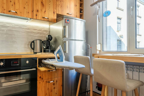 Ironing board with iron on your disposal in the kitchen