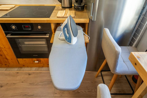 Ironing table with iron in the kitchen area