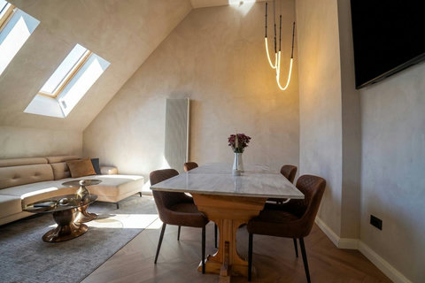 Open-plan dining and living area with designer lighting