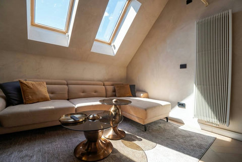 Sunlit living room with skylight windows and luxury sofa