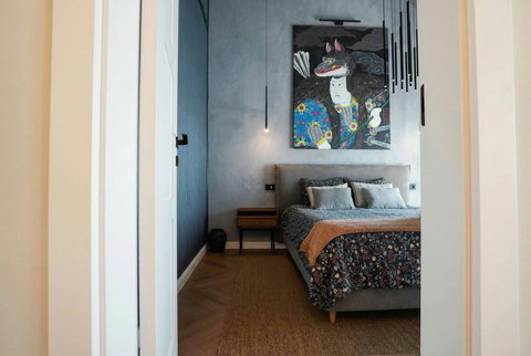 Bedroom entrance with bespoke wood-paneled corridor and designer details