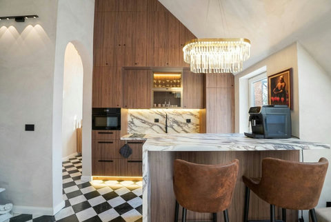 Chef's kitchen with premium appliances and marble-effect backsplash