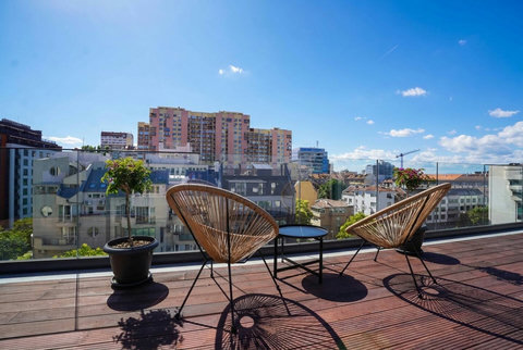 Terrace outdoor lounge — coffee and sunset over the Sofia skyline