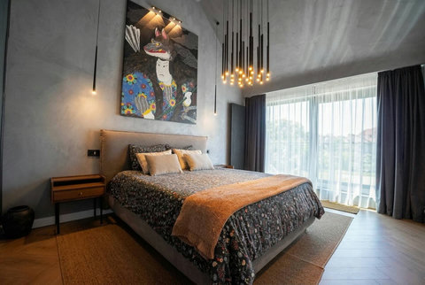 Designer bedroom with statement artwork and premium bedding