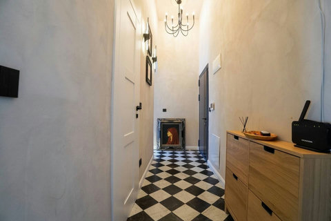 Stylish entrance hallway with checkered tile flooring and designer storage