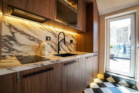 Designer kitchen with marble-effect sink and window view over Sofia