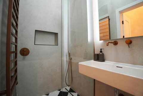 Sleek bathroom vanity with backlit mirror and heated towel rail
