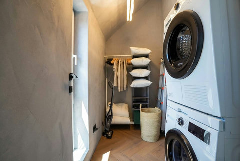 Private laundry room with washer, dryer and storage — perfect for longer stays