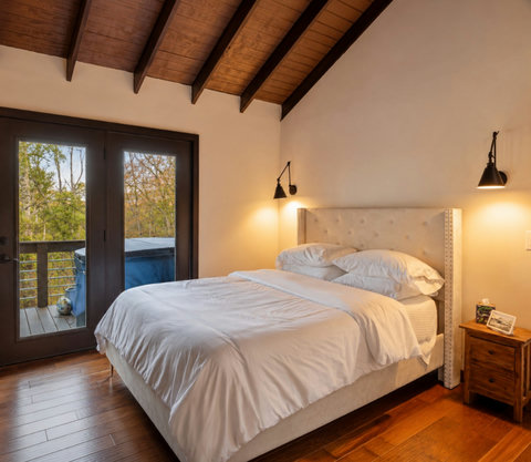 Guest Bedroom with TV, Deck access, and view