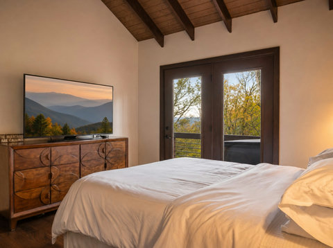 Guest Bedroom with TV, Deck access, and view