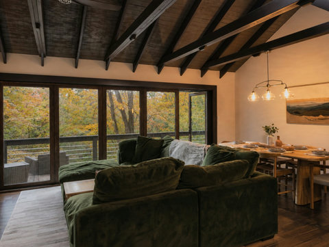 Living Room and Dining with deck access large windows and fireplace
