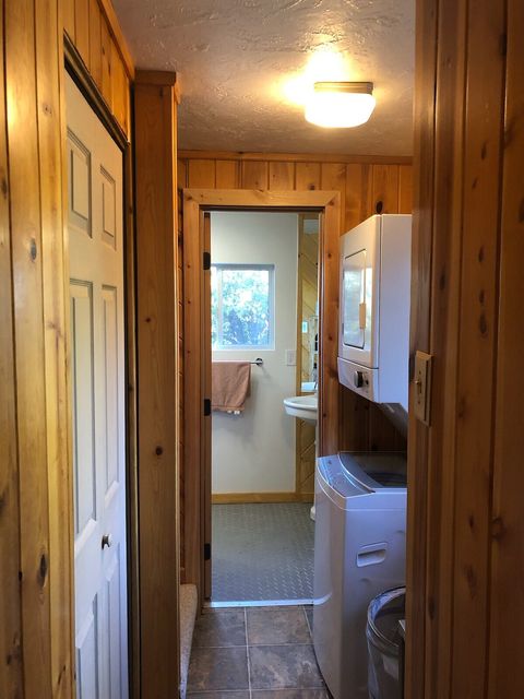 Hallway to bathroom, staircase and laundry area