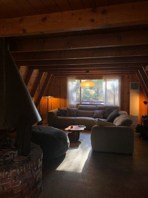 Wider view of the living room with Swedish oven style fireplace on the left of the frame