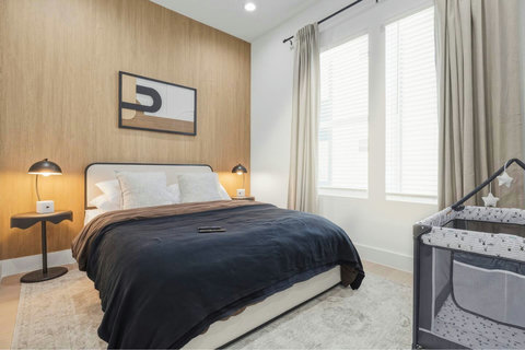 Relax in this cozy bedroom featuring a sleek wall‑mounted TV, a closet and your own private bathroom, perfect for comfort, privacy, and unwinding after a long day.