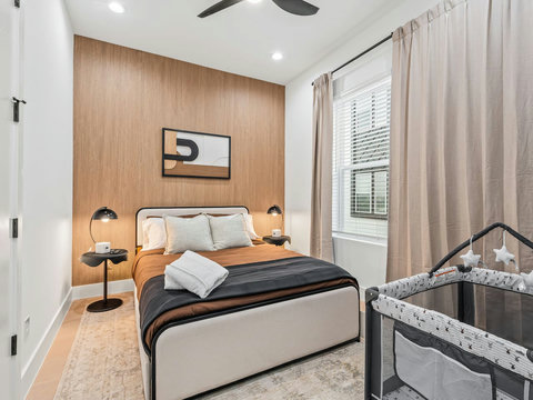 This beautifully appointed bedroom offers a serene and stylish escape, featuring soft neutral tones and a thoughtfully designed layout that balances comfort and elegance. 