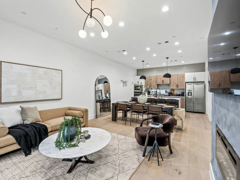 Welcome to our home, featuring seating for 12 and an open‑concept living area that overlooks the dining table and kitchen. A large arched floor mirror adds elegance and enhances the natural light throughout the space.
