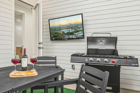 Relax and unwind in this stylish patio, designed for both comfort and fun. Enjoy a spacious dining area, cozy lounge seating, a wall‑mounted Smart TV, and a full grill setup, perfect for game nights, outdoor meals, or morning coffee. 