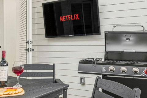 Relax and unwind in this stylish patio, designed for both comfort and fun. Enjoy a spacious dining area, cozy lounge seating, a wall‑mounted Smart TV, and a full grill setup, perfect for game nights, outdoor meals, or morning coffee. 
