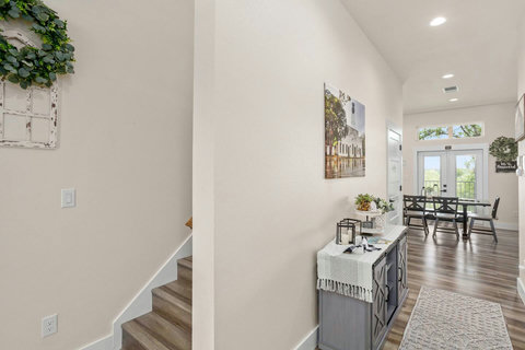 Bright entry with farmhouse charm, open dining and patio views