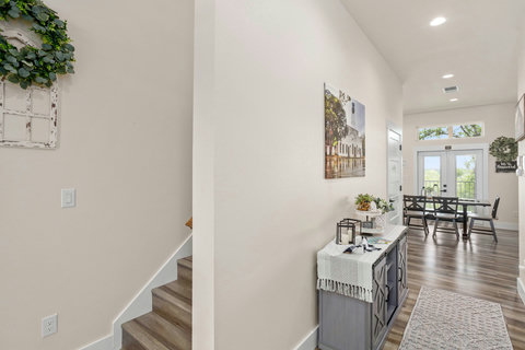 Sunny entry and open dining with high ceilings and patio-view doors.