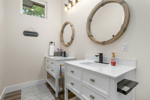 Stylish double-vanity bath with quartz tops & modern black fixtures