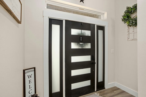 Bright entryway with modern frosted-glass door and warm wood floors