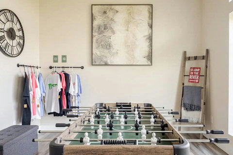 Our second-floor game room features huge windows with stunning river views and a foosball table for friendly competition. The perfect spot to unwind, play, and soak in the scenery at The Riverscape at Gruene!
