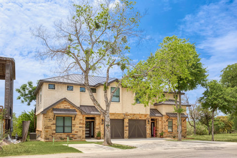 Modern Hill Country duplex with garages, shade trees, and a quiet setting