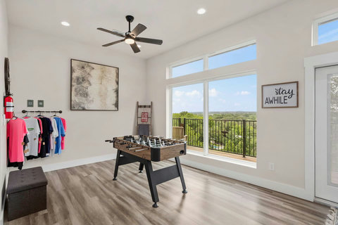 The game room features stunning river views and a foosball table for friendly competition. The perfect spot to unwind, play, and soak in the scenery.
