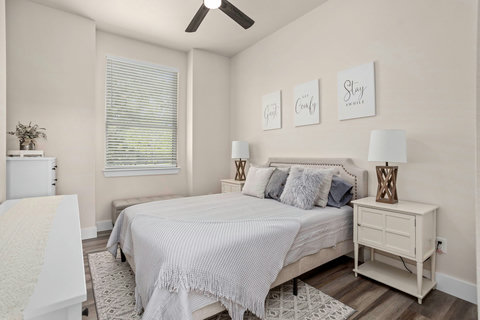 Serene, light-filled bedroom with queen bed, fan & chic decor