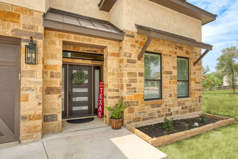 Stone façade home with modern entry and landscaped curb appeal
