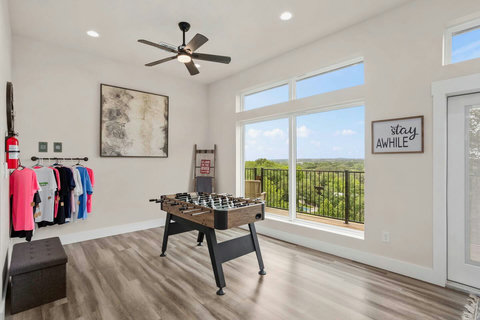 The game room features stunning river views and a foosball table for friendly competition. The perfect spot to unwind, play, and soak in the scenery.