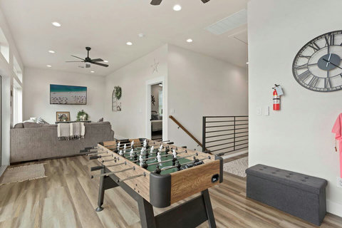The game room features stunning river views and a foosball table for friendly competition. The perfect spot to unwind, play, and soak in the scenery.