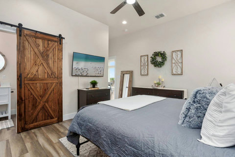 Welcome to our exquisite Master Ensuite haven, boasting ample space and comfort! Relax and unwind in a cozy king-size bed. Enjoy the natural light complemented by rustic decor. Wait until you see this oversized closet.