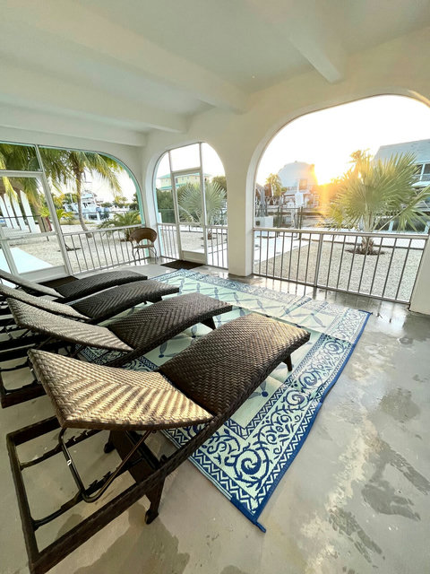 Lower screened in patio facing canal and sunset 