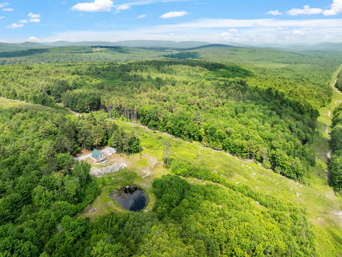 View of the A Frame House with Pond, and deck. There is also the ITS snowmobile trail shown along the pipeline. 