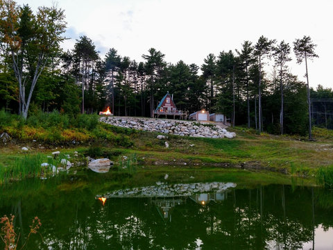 A Frame House with Pond And River lower down. 14 Acres.
