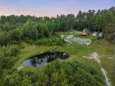 View of the pond and the house with the trail going down to the river. 