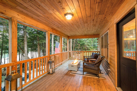 Deck with gas fireplace overlooking the waterfront of the lake house. Very private setting directly on the lake. 