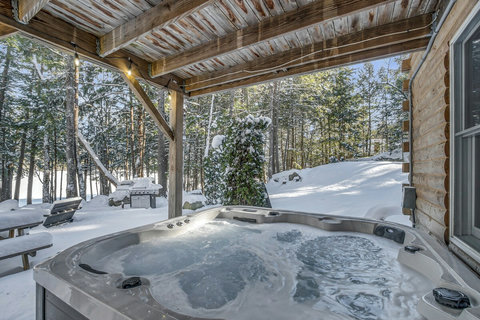 Clean hot tub overlooking the clean and sandy waterfront lake. 
