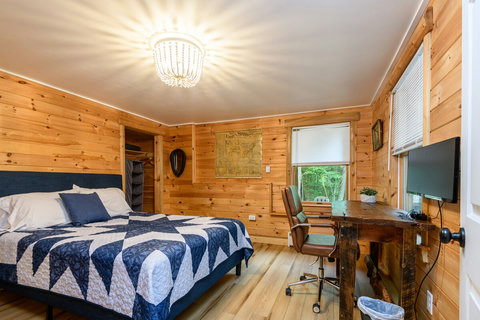 Bedroom 3 with a desk and computer that overlooks the pond. 