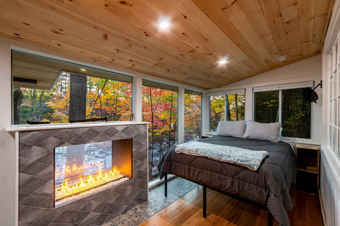 Gas Fireplace and bed overlooking the river. 
