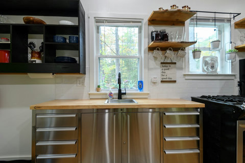 Clean but small kitchen with a full stove, fridge, microwave, freezer, and everything you need to cook or have the chef come by .