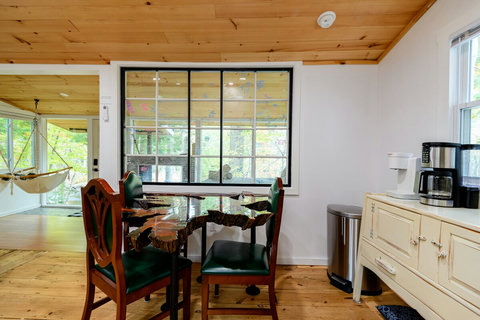Keurig and drip coffee with cool table. Pens to sign the window and a cool view of the rushing river