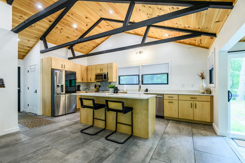 Kitchen with stainless fridge, dishwasher and water views. 
